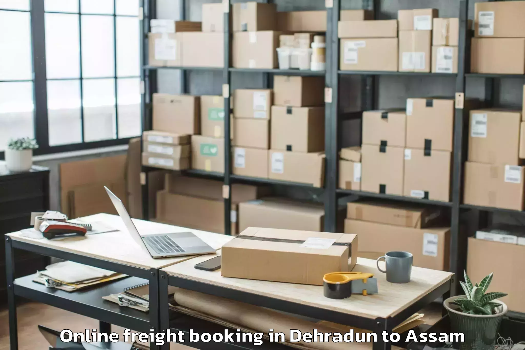 Hassle-Free Dehradun to Basugaon Online Freight Booking